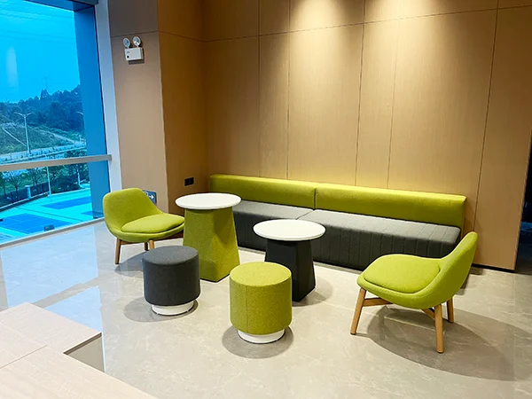 Commercial office project, green leisure accent chairs and long banquette sofa for small office lounge