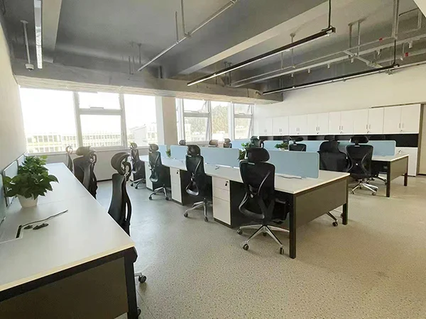 Commercial office fit-out project, industrial open workspace with black mesh ergonomic office chairs