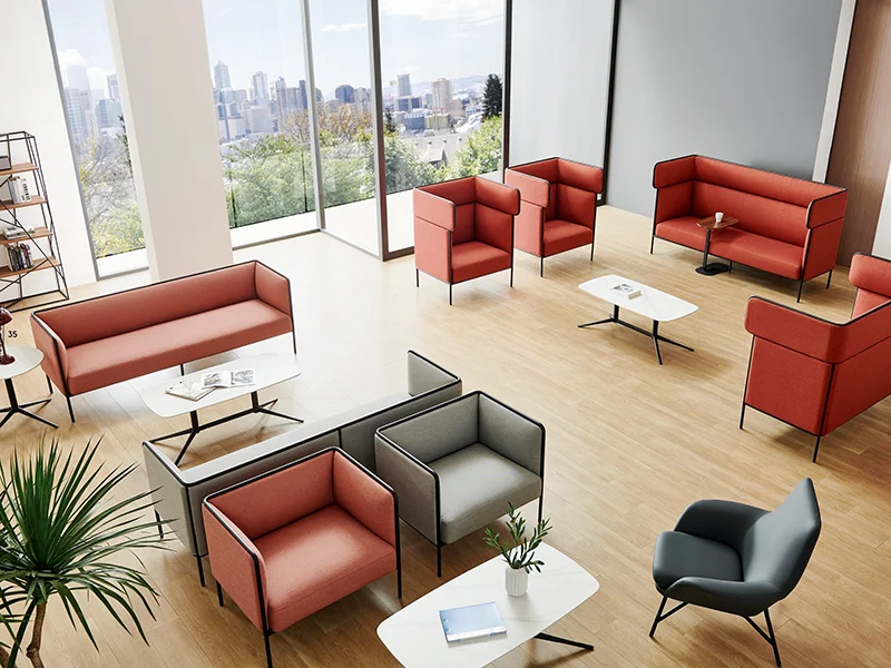 Modern office reception lounge area with red fabric office sofas and armchairs, large floor-to-ceiling windows, commercial waiting space furniture by Kepo Space