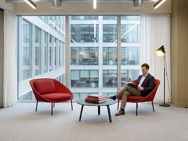 Office breakout lounge with red leisure reception chairs for casual meeting