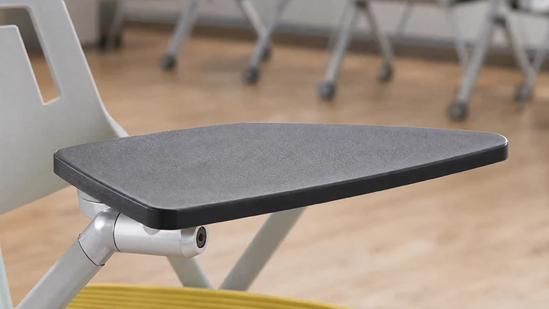 Close-up view of foldable writing tablet for training room chair